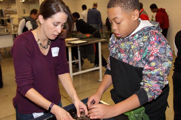 Courtney Price working with a student during the 2016 Breakfast of Science Champions 