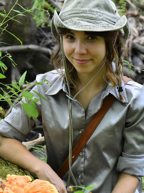TPS Fellow Nicolle Omiotek posing next to a mushroom in the field